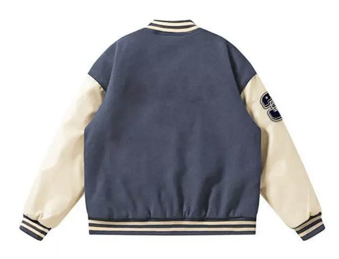 Untuk tampilan versatile, pertimbangkan jaket varsity yang bagian belakangnya polos